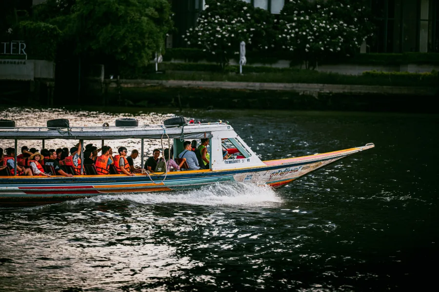 Travellers riding a Chao Phraya river boat